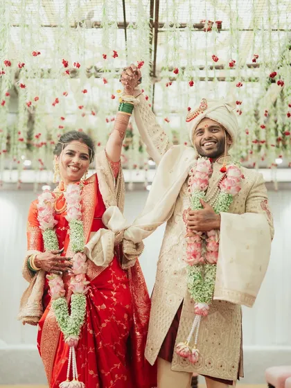 The triumphant couple, hand-in-hand, celebrating their union.