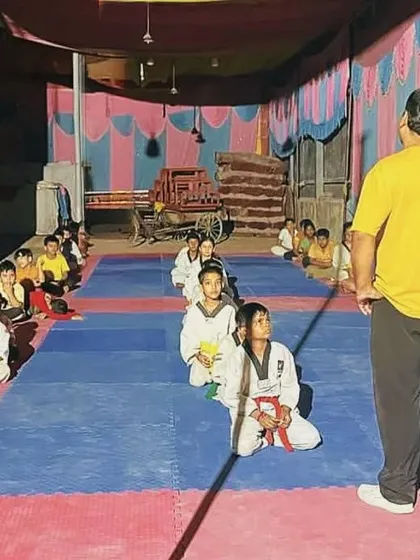 A great coach can change a life. Here I am addressing my class of young, aspiring martial artists, instilling the discipline and focus needed to succeed both on and off the mat.