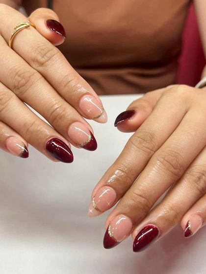 Another look at the deep red French tip with a gold glitter line. This classic combination is always a client favorite.