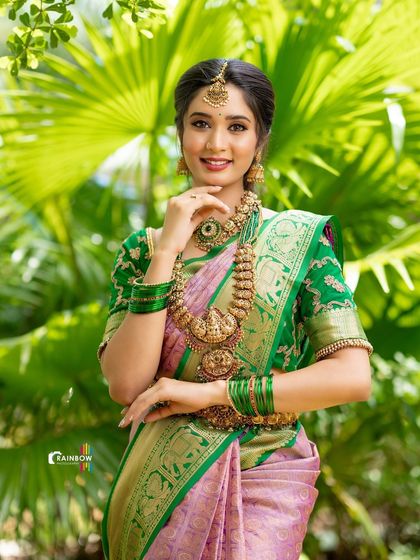 A close-up portrait focusing on the model's serene expression and the intricate details of her traditional gold jewelry.