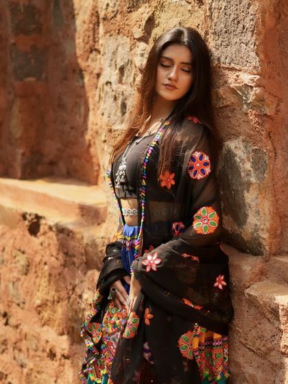 Leaning against the wall, this pose is full of grace and traditional charm.