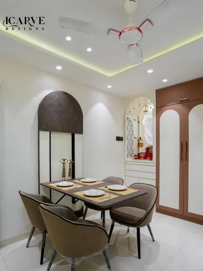 A straight-on view of the dining table, set against the backdrop of the elegant pooja unit.