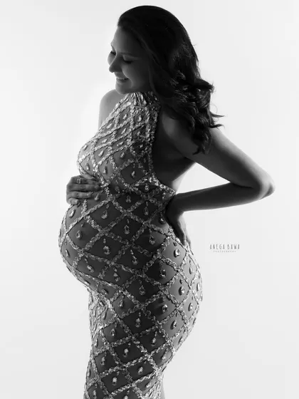 A profile view of the jeweled gown in black and white. The lighting sculpts the body beautifully, creating a glamorous and artistic portrait.