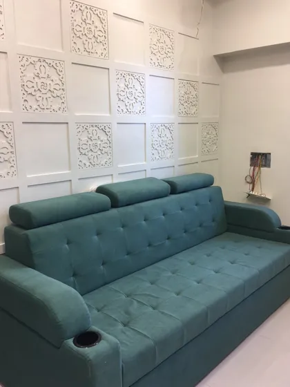 This is a custom-made sofa that also functions as a comfortable bed. It features adjustable headrests and convenient cup holders, making it a perfect multi-functional piece for any living room.