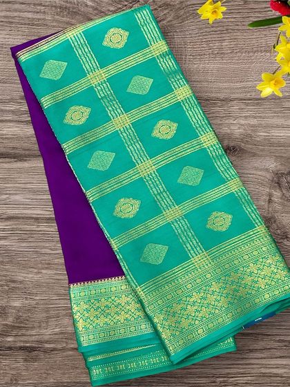 A half-and-half pure Mysore crepe silk saree featuring a rich purple body and a sea green pallu with a diamond butta pattern.