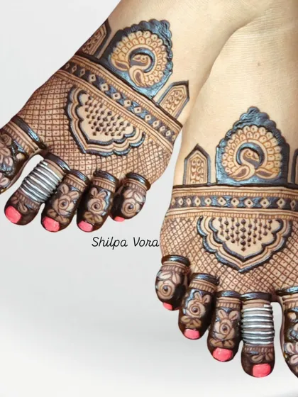A beautiful peacock-themed design for the feet, with intricate details on the toes.