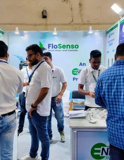 A wide shot of our booth buzzing with activity. Visitors and team members engage in conversations about sustainable water management solutions.