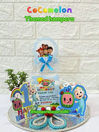 A Cocomelon-themed hamper for Raunak's first birthday, featuring all the favorite characters, a planter, and tasty treats.