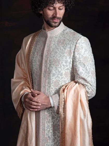 Here, the focus is on the intricate, tone-on-tone embroidery of the sherwani. The craftsmanship is meant to be admired up close, showcasing a level of detail that defines true bespoke luxury.
