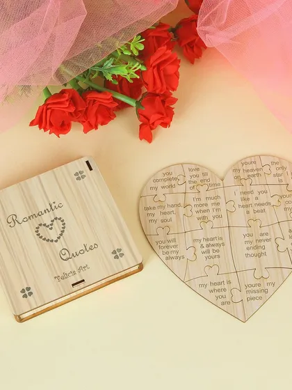 We photograph unique gift items like this heart-shaped wooden puzzle with romantic quotes, styled with flowers to enhance its sentimental value.