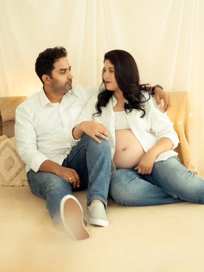 A relaxed and happy couple's portrait on a bed setup in our studio, perfect for a casual lifestyle feel.