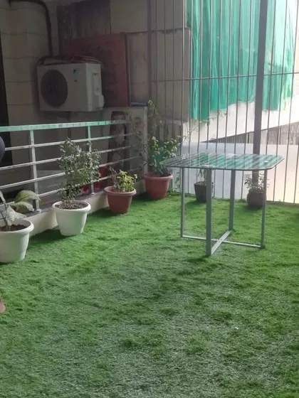 My team ensuring a perfect fit for the grass installation in this Gurgaon balcony.
