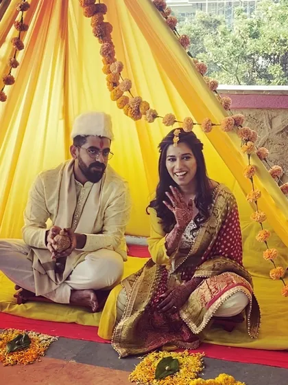 A happy moment from a Haldi ceremony. The bride's makeup is minimal and fresh, perfect for the occasion.