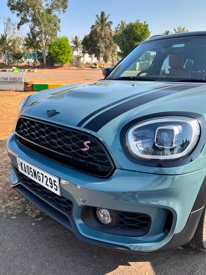 A detailed shot of the front grille and headlight of a Mini Countryman S at the track.