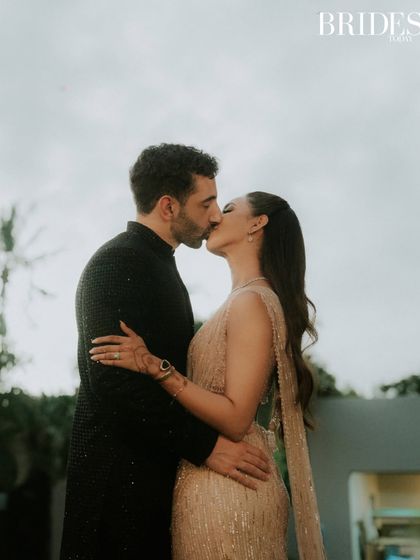 An intimate kiss shared by the couple, captured for Brides Today. This close-up emphasizes the romance and emotion of their wedding day in Mauritius, a moment of pure, unscripted love.