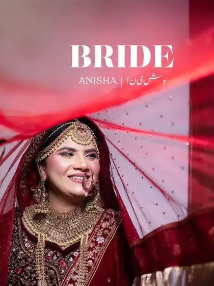 "BRIDE." A powerful portrait of the smiling bride under her red veil, capturing her beauty and joy.
