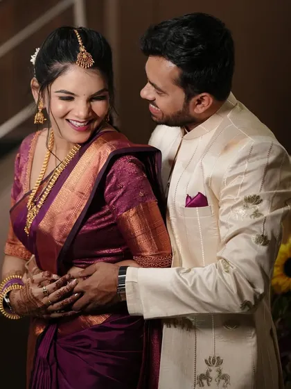 A happy, candid embrace. This photo captures the joy of the couple and the bride's glowing makeup.