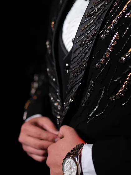 The difference is in the details. This close-up reveals the intricate hand-embroidery and sequin work on one of our signature tuxedos, showcasing the precision and artistry that goes into every bespoke piece we create.