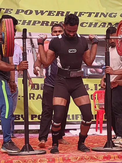 An athlete preparing to squat at the State Meet. The focus and intensity are palpable.