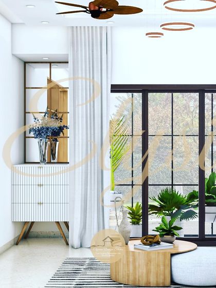 A corner detail of a living room, showing a sleek white chest of drawers next to a large window, demonstrating how we use furniture to create functional and beautiful nooks.