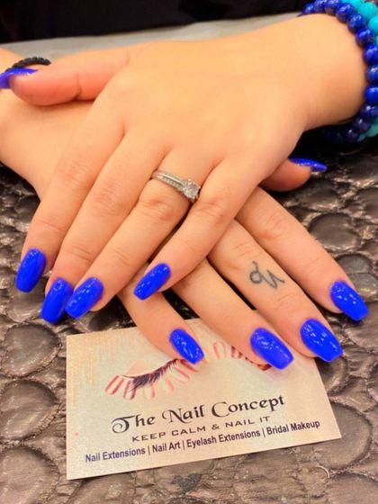 A stunning set of long, square-shaped nails in a vibrant, electric blue. The glossy finish makes this bold color pop even more.