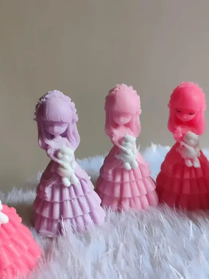 Beautiful doll soaps in shades of pink and purple, with detailed dresses.