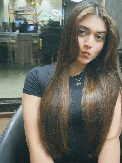 The client showing off her new hair color. The face-framing highlights add a beautiful touch.