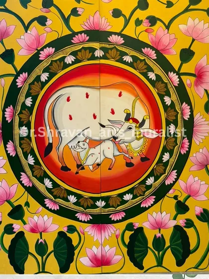 The elegance of traditional Pichwai art is timeless. This piece, featuring a sacred cow and calf surrounded by lotuses, was painted on a large canvas to serve as a vibrant, spiritual centerpiece in the client's home.