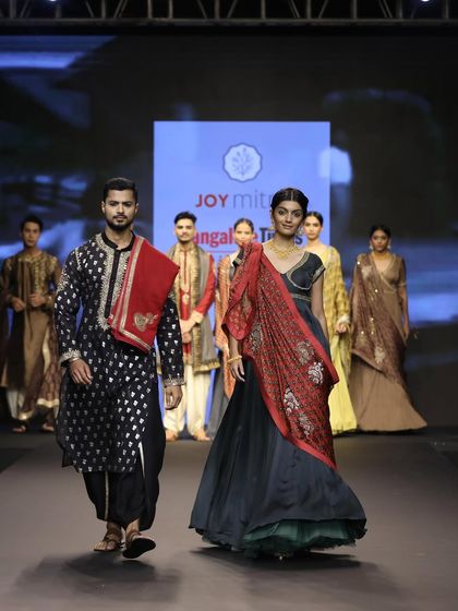 Walking the ramp for Joy Mitra, this shot captures the flow of the traditional garments and the dynamic between the models.