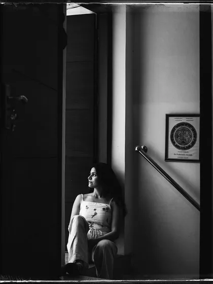 Kirtika, the very first portrait from my 'Doorways' series. This shot, with its deep shadows and contemplative mood, set the tone for the entire project.