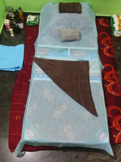 This is my clean and hygienic setup for a body treatment session. I always use fresh towels and disposable sheets to ensure your comfort and safety, both at my place and for home service.
