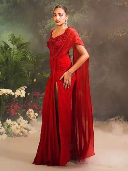 A starlit moment, wrapped in luxury. Our Stardust Saree Set in a passionate red brings together the perfect fusion of a structured corset and a timelessly elegant draped saree.