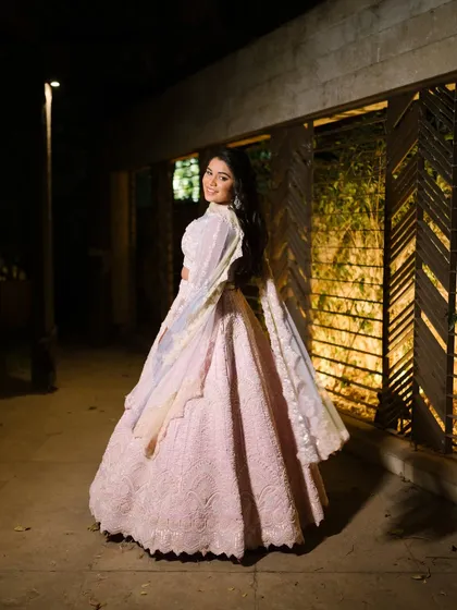 A beautiful shot showing the back of the gown and the bride's elegant pose. The entire look is a fairytale come to life.