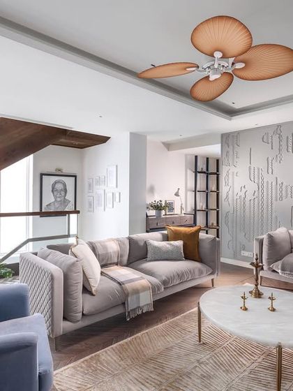 This view of the AMARA living room highlights the comfortable, modern furniture and the unique fan, which adds a touch of tropical elegance. The space is designed to be both calming and welcoming, perfect for a modern family.