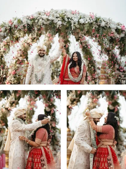The varmala ceremony, a beautiful explosion of joy, laughter, and flower petals under a stunning floral arch.