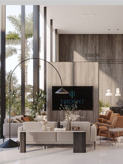 The reception area at Trident Realty features open layouts, soaring ceilings, and a warm material palette to foster relaxation and engagement. Expansive windows frame the outdoors, creating a refined blend of style and contemporary elegance.