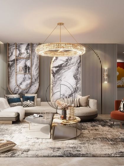 A well-composed family lounge featuring a neutral curved sectional, a bold marble feature wall, and fluted panel details. A crystal chandelier adds focus, while burnt orange chairs bring contrast and depth.