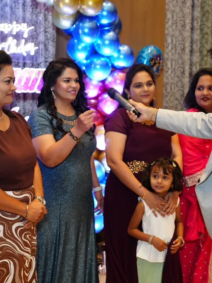 A sweet moment interacting with a young guest and her mother at a birthday party. I make sure even the youngest attendees feel special.