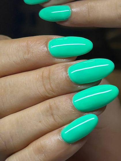 A bright, minty green manicure. This fresh and playful color is perfect for summer and adds a fun pop to any look.