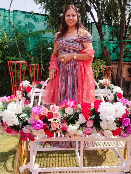 Posing on a beautiful floral-decorated carriage at a Haldi event. The decor was so dreamy and perfect for photos.