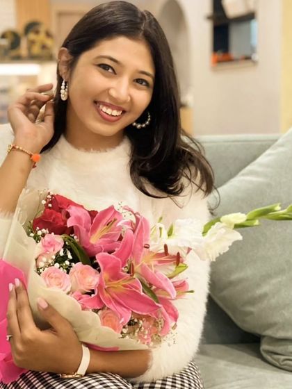 A portrait of our founder, holding a fresh bouquet. This image represents our core mission: to gift smiles and spread joy, one beautiful arrangement at a time.