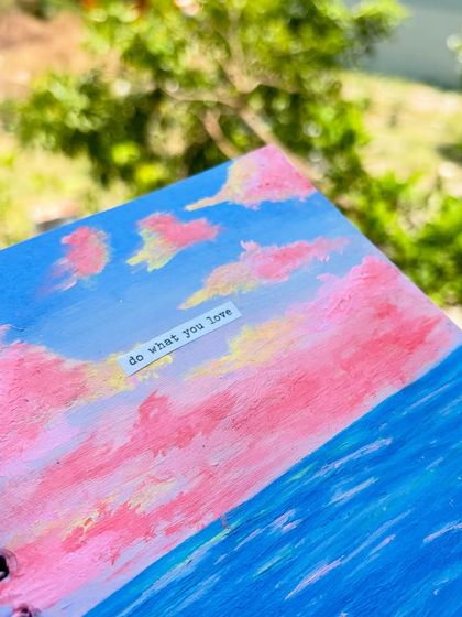 A close-up of the sketchbook painting, focusing on the texture of the acrylic paint and the motivational quote.