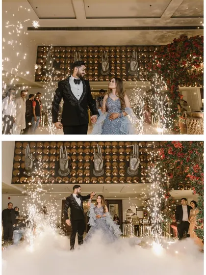 A fairytale entrance for a modern couple. Surrounded by sparklers and a cloud of smoke, this couple makes their grand entrance, ready to celebrate their love. This shot captures the glamour and excitement of a reception party.