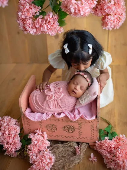 Big sister giving her new baby sibling a gentle kiss. Sibling shots are so important for capturing the start of a lifelong friendship.