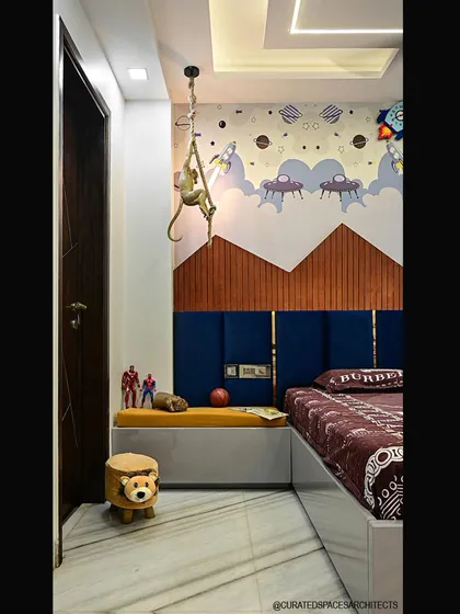 A closer look at the details in this fun kid's bedroom. The design includes a cushioned bench for seating and storage, along with a playful monkey lamp that adds a touch of whimsy.