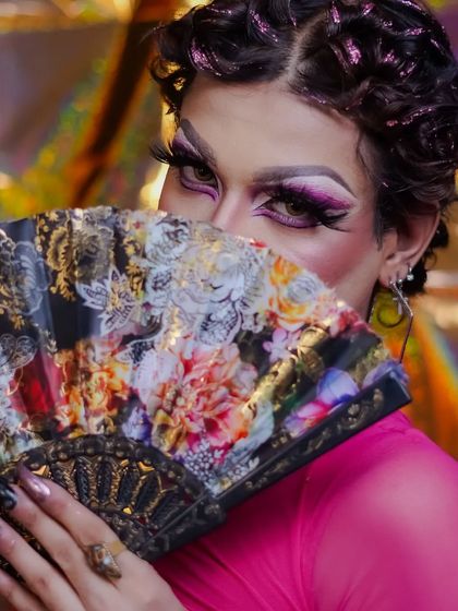 A mysterious and alluring shot, using the fan to draw attention to the eyes.