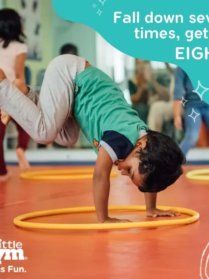 A boy practices a handstand variation using a hula hoop, demonstrating resilience and determination. We teach kids that it's okay to fall, because getting back up is how you get stronger.