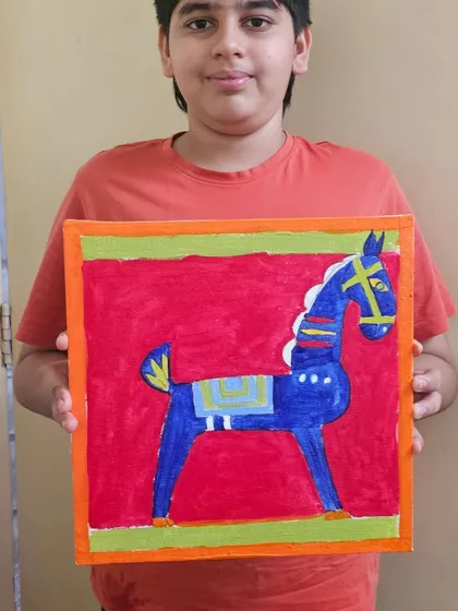 A student with his beautiful recreation of a Jamini Roy folk art painting, showcasing the bold lines and colors characteristic of the master's style.