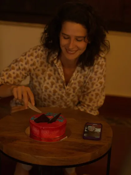 A smile of pure joy as our guest cuts her birthday cake. We believe that celebrating life and creating happy memories is an essential part of the healing process.