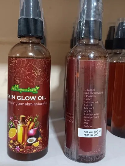 A close look at the Skin Glow Oil bottle, showing the front label and the list of natural ingredients on the back. You can see everything that goes into it, like licorice, red sandalwood, carrot, and saffron.